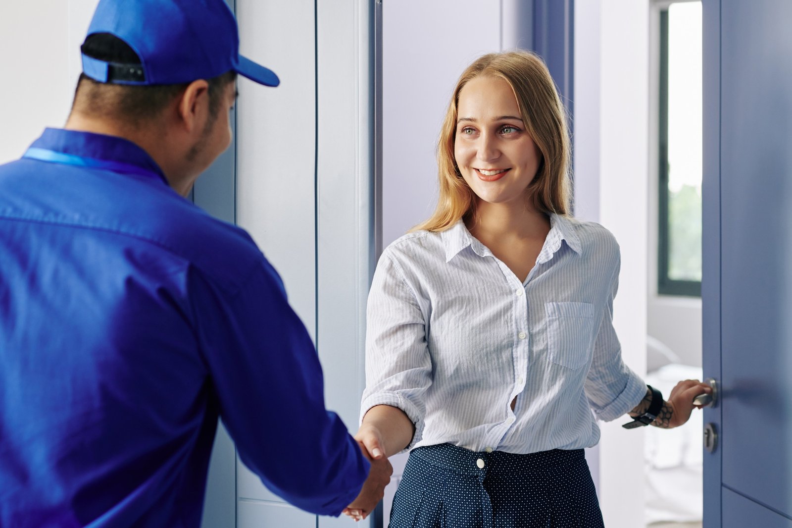 Young woman greeting Arghco handyman
