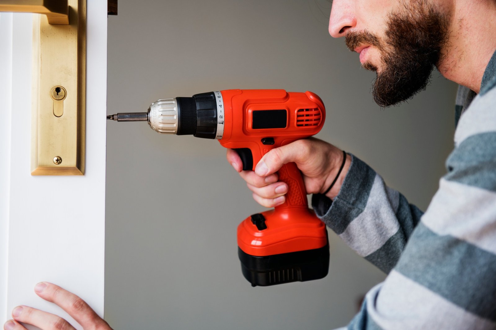 Man using electronic drill install door