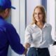 young woman greeting repairman 80x80