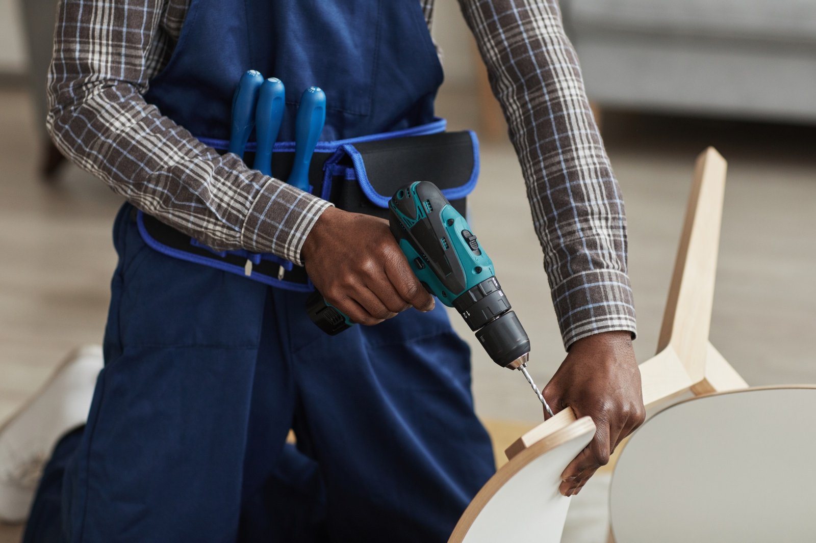 African American Handyman Assembling Furniture Close Up