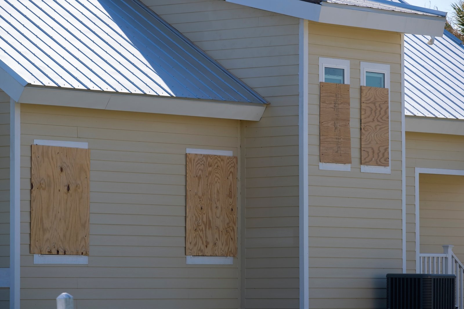 Boarded up windows with plywood storm shutters for hurricane protection