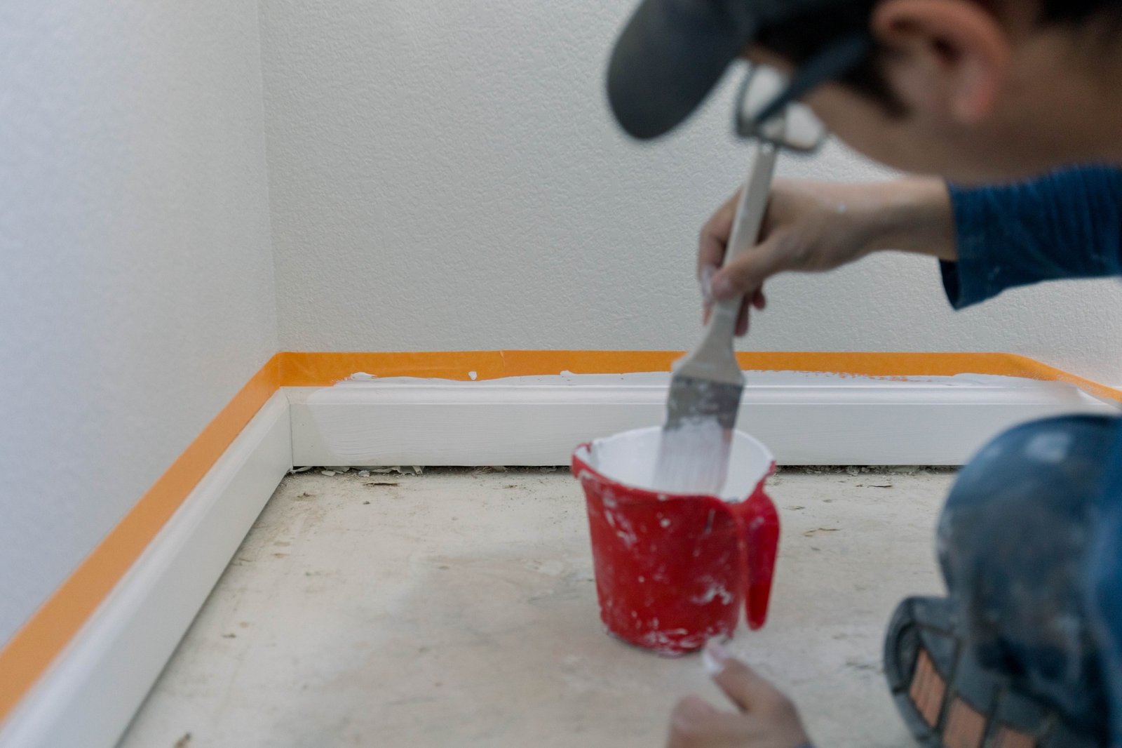 Man painting a room white on a home remodel